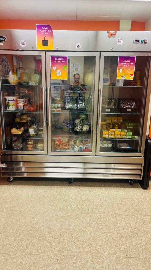 Refrigerated grocery section at Ventura College’s Basic Needs Center displaying fresh produce, dairy items, and labeled selection limits for students.