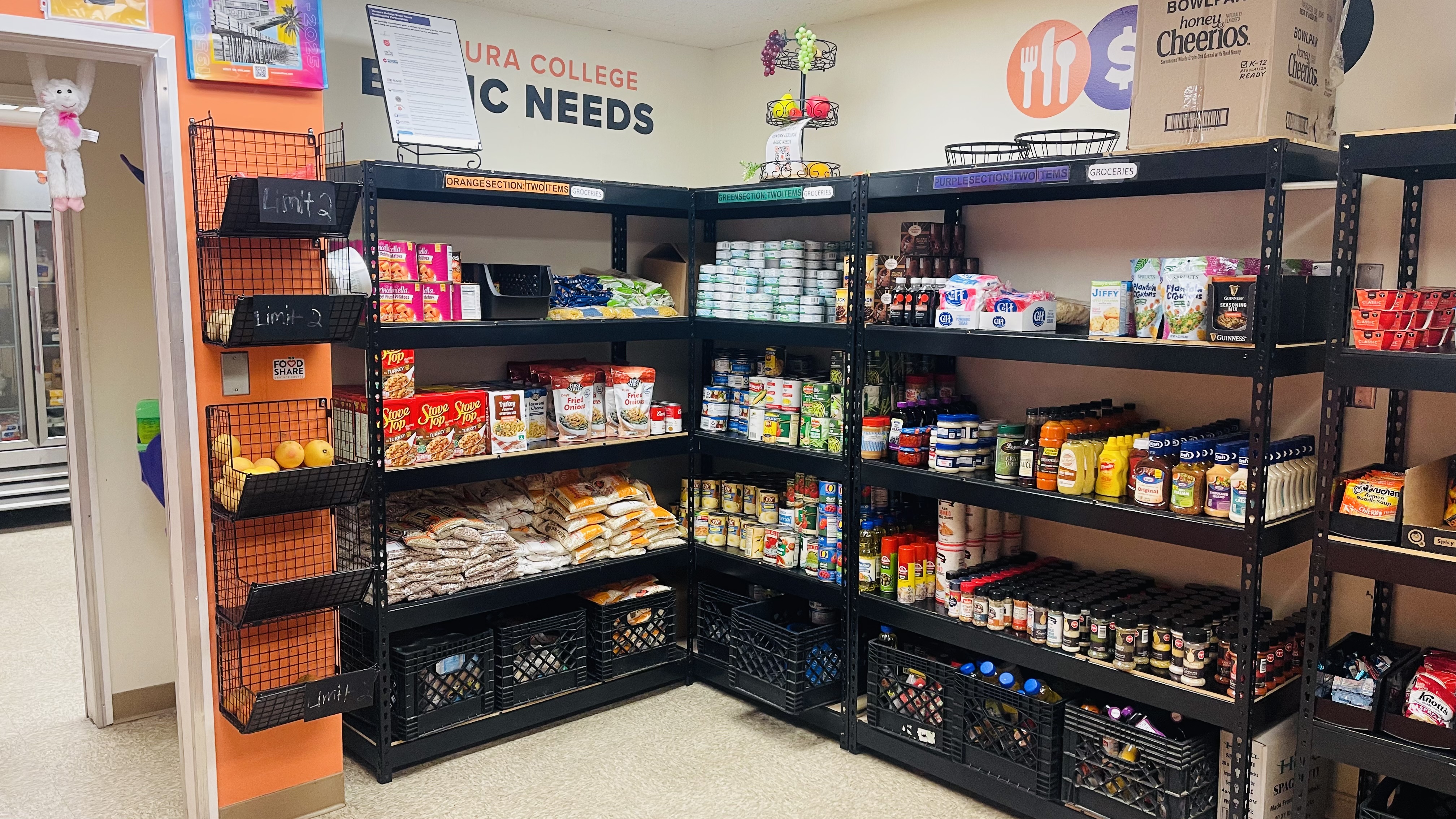 Shelving units inside Ventura College’s Basic Needs Center stocked with canned goods, boxed foods, grains, and clearly labeled section limits.